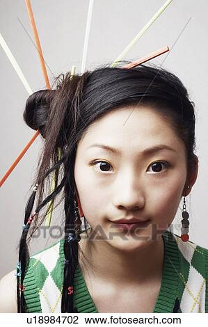 Stock Image - Portrait of a young woman with a hairdo. Fotosearch