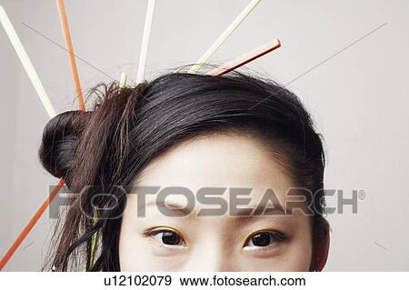 Portrait of a young woman with a hairdo View Large Photo Image Stock Photo - Portrait of a young woman with a hairdo. Fotosearch