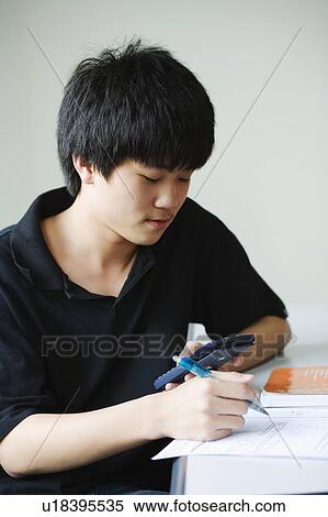 Close-up of a boy holding calculator View Large Photo Image Stock Photography - Close-up of a boy holding calculator. Fotosearch
