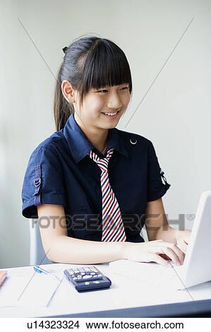 Picture - Close-up of a girl using a laptop. Fotosearch