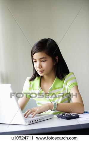 Close-up of a girl using a laptop View Large Photo Image Stock Image - Close-up of a girl using a laptop. Fotosearch
