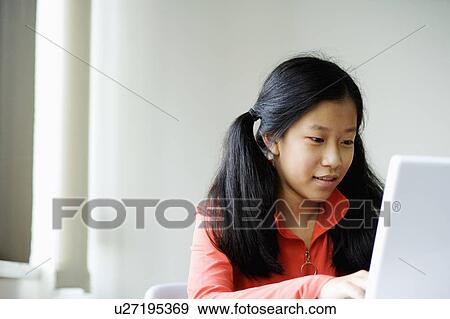Close-up of a girl using a laptop View Large Photo Image Stock Photo - Close-up of a girl using a laptop. Fotosearch