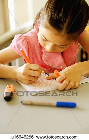 Close-up of a girl writing on a spiral notebook in the classroom View Large Photo Image Stock Photograph - Close-up of a girl writing on a spiral notebook in the classroom. Fotosearch