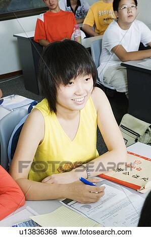 High angle view of a teenage girl sitting in the classroom View Large Photo Image Stock Photo - High angle view of a teenage girl sitting in the classroom. Fotosearch