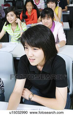 High angle view of students sitting in a classroom View Large Photo Image Stock Image - High angle view of students sitting in a classroom. Fotosearch
