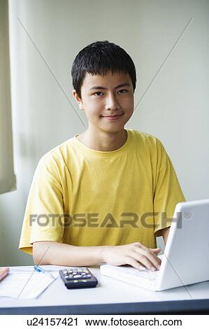 Portrait of a boy using a laptop View Large Photo Image Stock Image - Portrait of a boy using a laptop. Fotosearch