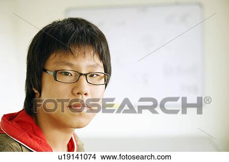 Picture - Portrait of a teenage boy in the classroom. Fotosearch