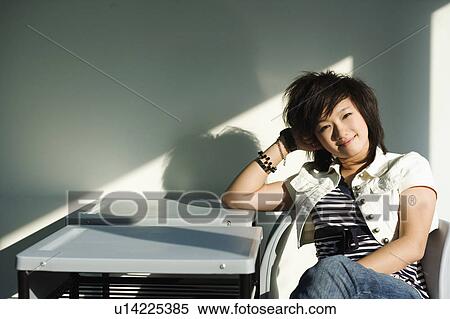 Stock Photography - Portrait of a teenage girl sitting in the classroom. Fotosearch