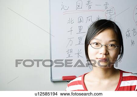Portrait of a young woman in the classroom View Large Photo Image Picture - Portrait of a young woman in the classroom. Fotosearch