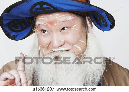 Stock Photo - Close-up of a mid adult man pointing up. Fotosearch