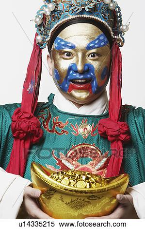 Portrait of a male Chinese opera performer holding a bowl full of gold coins View Large Photo Image Stock Photography - Portrait of a male Chinese opera performer holding a bowl full of gold coins. Fotosearch