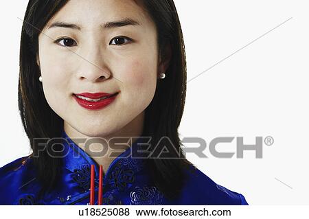 Stock Photo - Portrait of a young woman holding chopsticks. Fotosearch