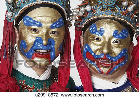 Stock Image - Portrait of two male Chinese opera performers smiling. Fotosearch