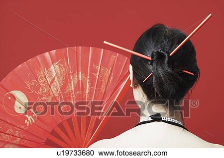 Stock Image - Rear view of a mid adult woman. Fotosearch