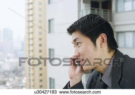 Stock Image - Close-up of a businessman using a mobile phone. Fotosearch