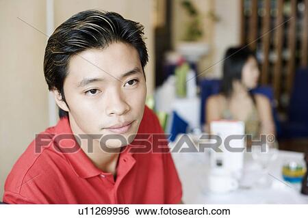 Stock Photograph - Close-up of a young man in a restaurant. Fotosearch