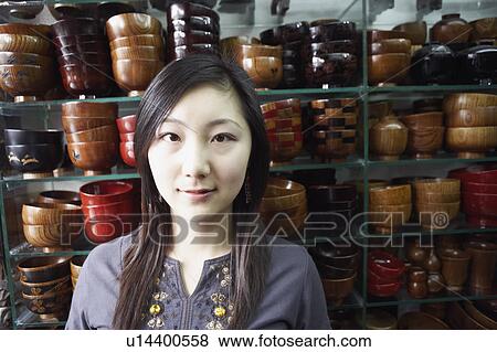 Close-up of a young woman in a store View Large Photo Image Stock Photo - Close-up of a young woman in a store. Fotosearch