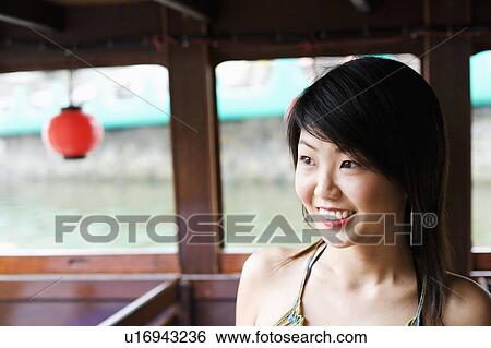 Stock Photograph - Close-up of a young woman smiling. Fotosearch