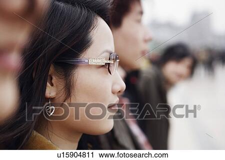 Stock Image - Close-up of a young woman wearing sunglasses. Fotosearch