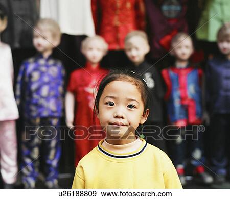 Stock Photo - Portrait of a girl standing in a clothing store. Fotosearch