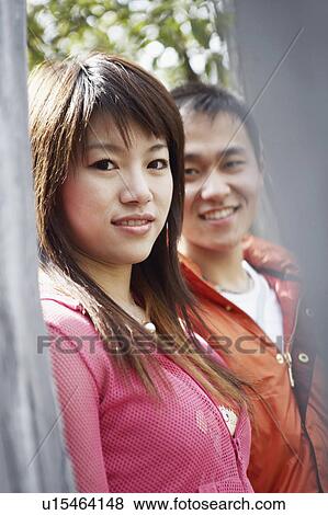 Stock Photo - Portrait of a young couple smiling. Fotosearch