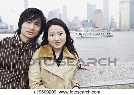 Portrait of a young couple smiling View Large Photo Image Stock Photo - Portrait of a young couple smiling. Fotosearch