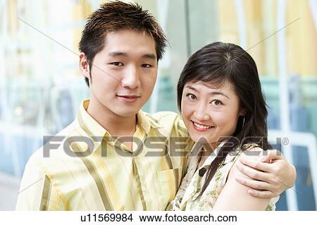 Picture - Portrait of a young man embracing a young woman. Fotosearch