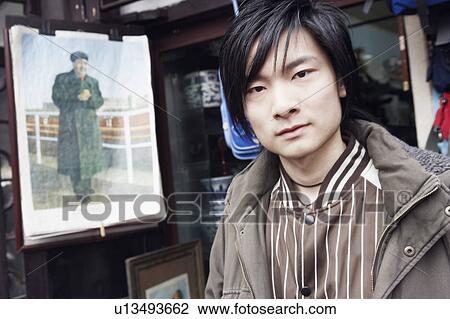Portrait of a young man in a store View Large Photo Image Stock Image - Portrait of a young man in a store. Fotosearch
