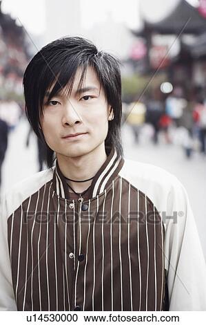 Stock Image - Portrait of a young man standing. Fotosearch