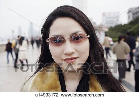 Stock Image - Portrait of a young woman smiling. Fotosearch