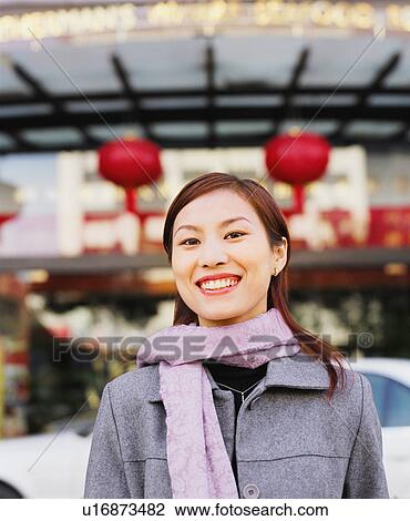 Stock Image - Portrait of a young woman smiling. Fotosearch