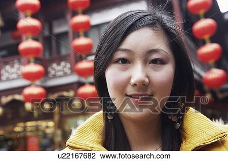 Stock Image - Portrait of a young woman smiling. Fotosearch
