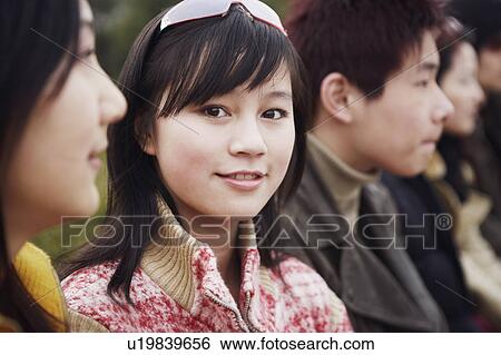 Stock Photograph - Portrait of a young woman smiling. Fotosearch