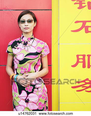 Stock Image - Portrait of a young woman standing. Fotosearch