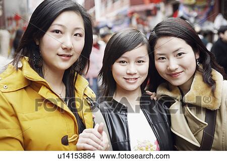 Picture - Portrait of three young women smiling. Fotosearch