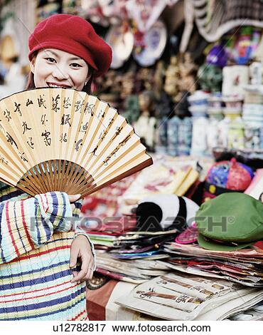 Portrait of young woman holding a folding fan View Large Photo Image Stock Photo - Portrait of young woman holding a folding fan. Fotosearch