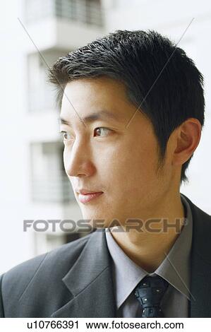 Stock Image - Close-up of a businessman looking away. Fotosearch