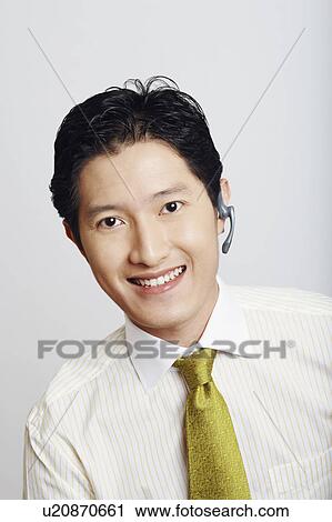 Stock Image - Portrait of a businessman smiling. Fotosearch