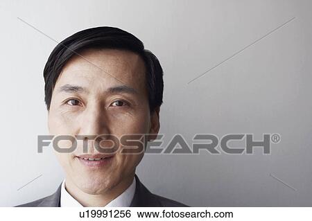 Stock Photograph - Portrait of a businessman smiling. Fotosearch