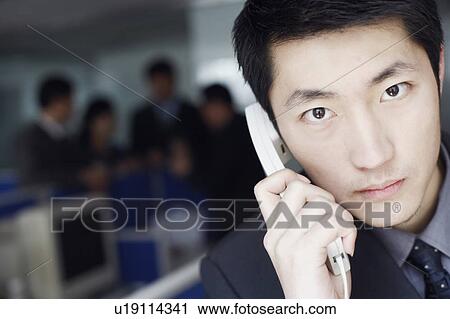 Portrait of a businessman talking on the telephone View Large Photo Image Stock Image - Portrait of a businessman talking on the telephone. Fotosearch