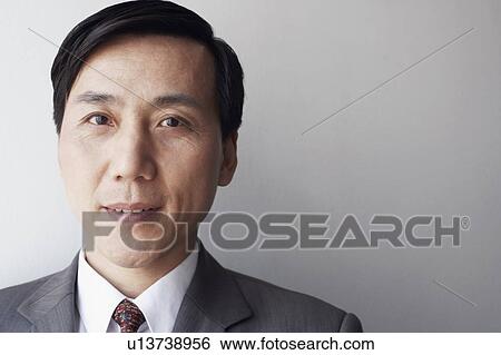 Stock Photograph - Portrait of a businessman thinking. Fotosearch