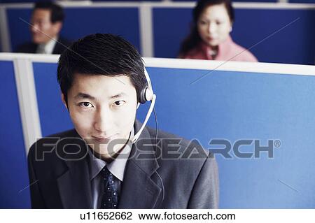 Stock Image - Portrait of a businessman wearing a headset. Fotosearch