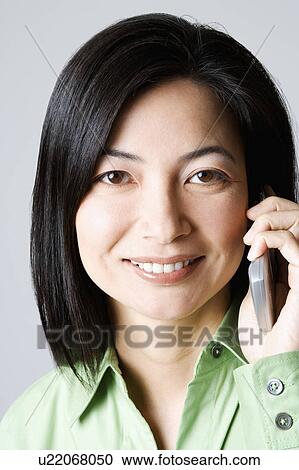 Stock Image - Portrait of a businesswoman talking on a mobile phone. Fotosearch