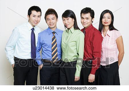 Stock Photo - Portrait of five business executives standing together and smiling. Fotosearch
