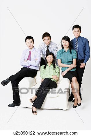 Portrait of two businesswomen and three businessmen smiling View Large Photo Image Stock Image - Portrait of two businesswomen and three businessmen smiling. Fotosearch