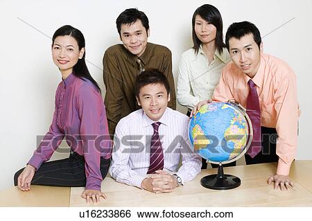 Stock Photograph - Portrait of two businesswomen and three businessmen smiling. Fotosearch