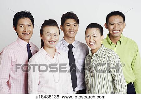 Portrait of two businesswomen and three businessmen smiling View Large Photo Image Stock Photography - Portrait of two businesswomen and three businessmen smiling. Fotosearch