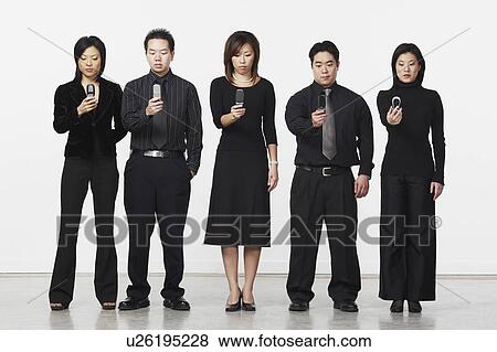 Stock Photo - Three businesswomen and two businessmen holding mobile phones. Fotosearch