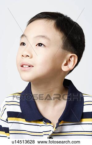 Stock Photo - Close-up of a boy looking away. Fotosearch