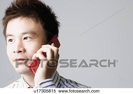 Stock Photography - Close-up of a businessman talking on a mobile phone. Fotosearch